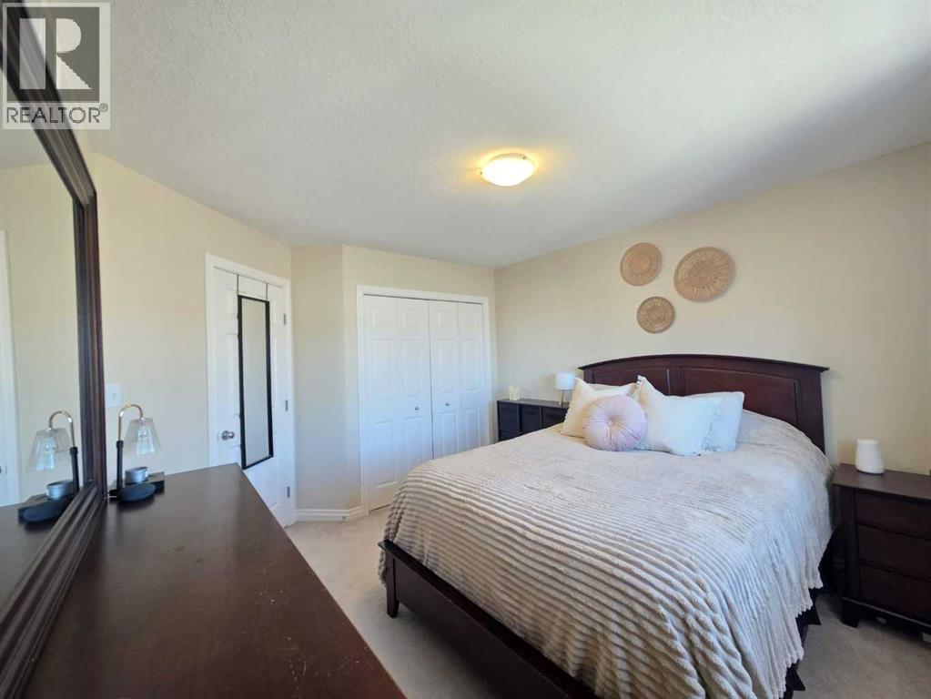 Primary Bedroom - 1, 2602 11 Avenue, Wainwright, AB - Indoor Photo Showing Bedroom