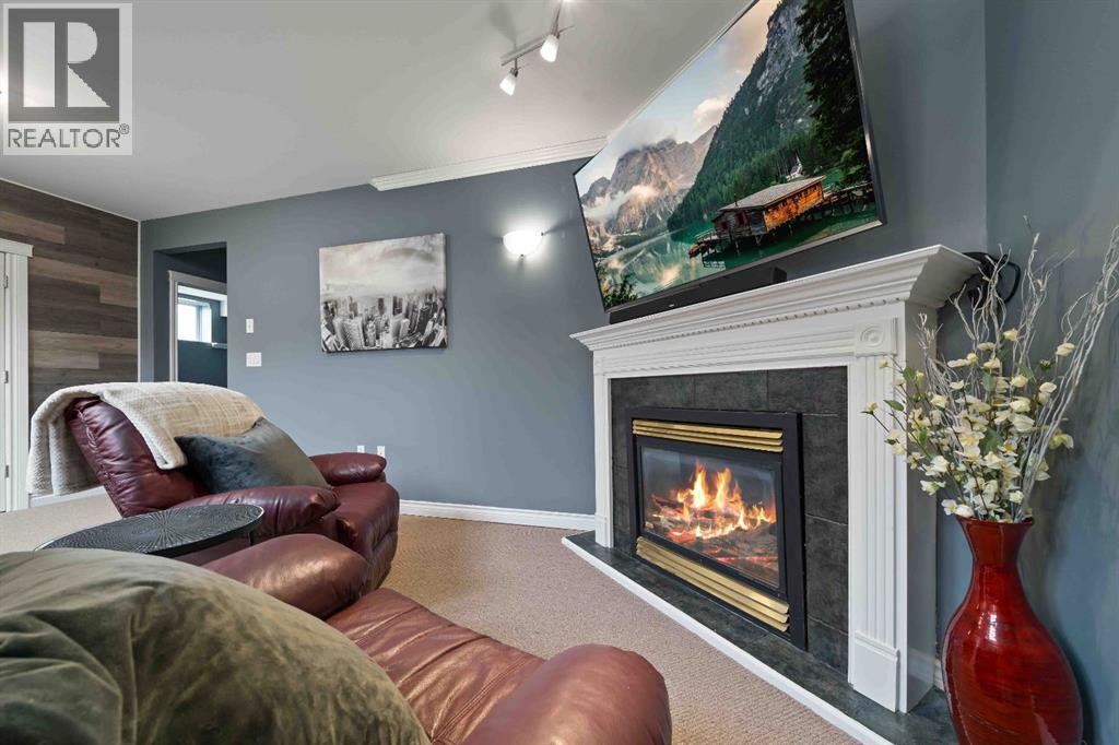 110 Redcliff Way Sw, Redcliff, AB - Indoor Photo Showing Living Room With Fireplace