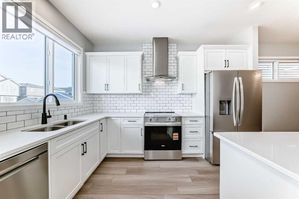 32 Creekview Common Sw, Calgary, AB - Indoor Photo Showing Kitchen With Stainless Steel Kitchen With Double Sink With Upgraded Kitchen
