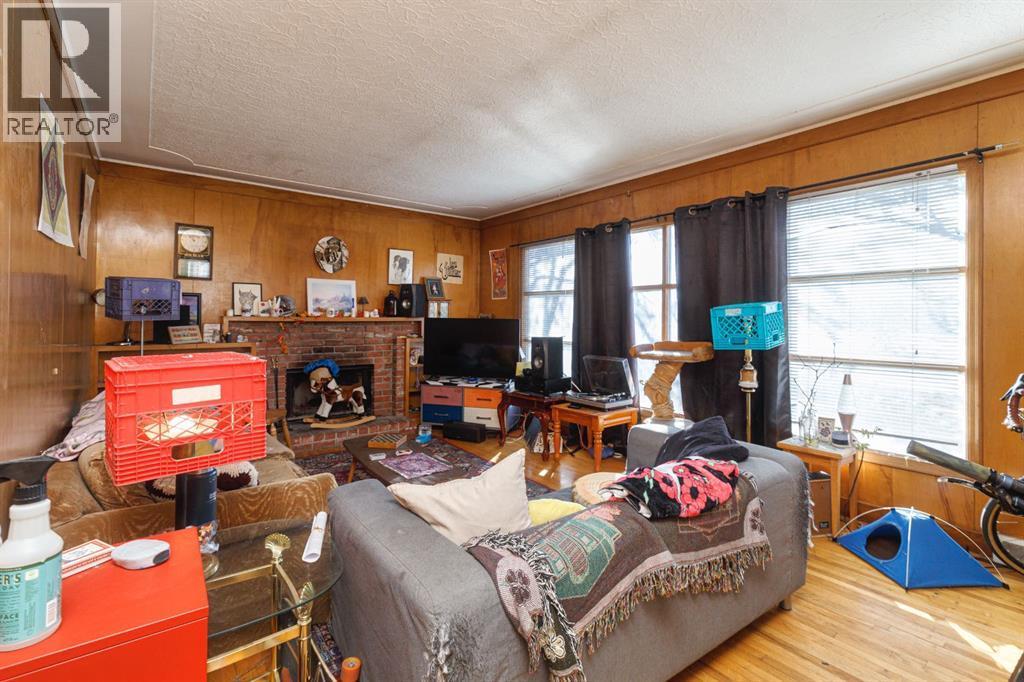 2824 Parkdale Boulevard Nw, Calgary, AB - Indoor Photo Showing Living Room With Fireplace