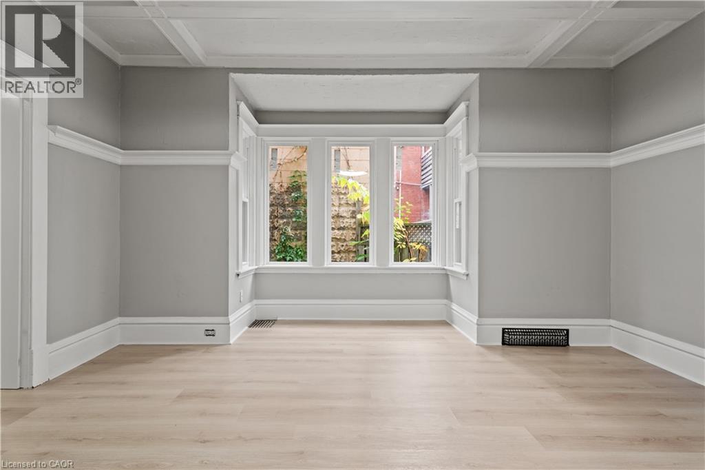 Spare room with light wood-style flooring and coffered ceiling - 88 Gage Avenue S, Hamilton, ON - Indoor