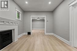 Unfurnished living room featuring light wood-style floors, a fireplace, and recessed lighting -