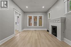 Unfurnished living room featuring light wood finished floors, a fireplace, and recessed lighting -