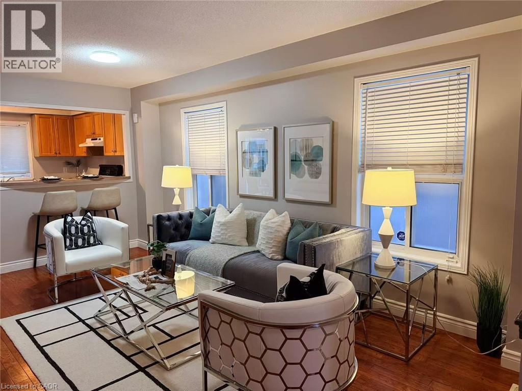 Living room featuring dark wood-style floors and a textured ceiling - 2258 Empire Crescent, Burlington, ON - Indoor Photo Showing Living Room