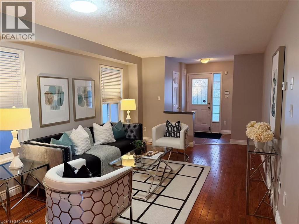Living area featuring dark wood finished floors and a textured ceiling - 2258 Empire Crescent, Burlington, ON - Indoor Photo Showing Living Room