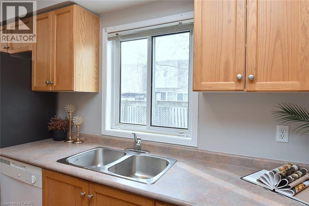 Kitchen featuring light countertops, dishwasher, and light brown cabinets - 2258 Empire Crescent, Burlington, ON - Indoor Photo Showing Kitchen With Double Sink
