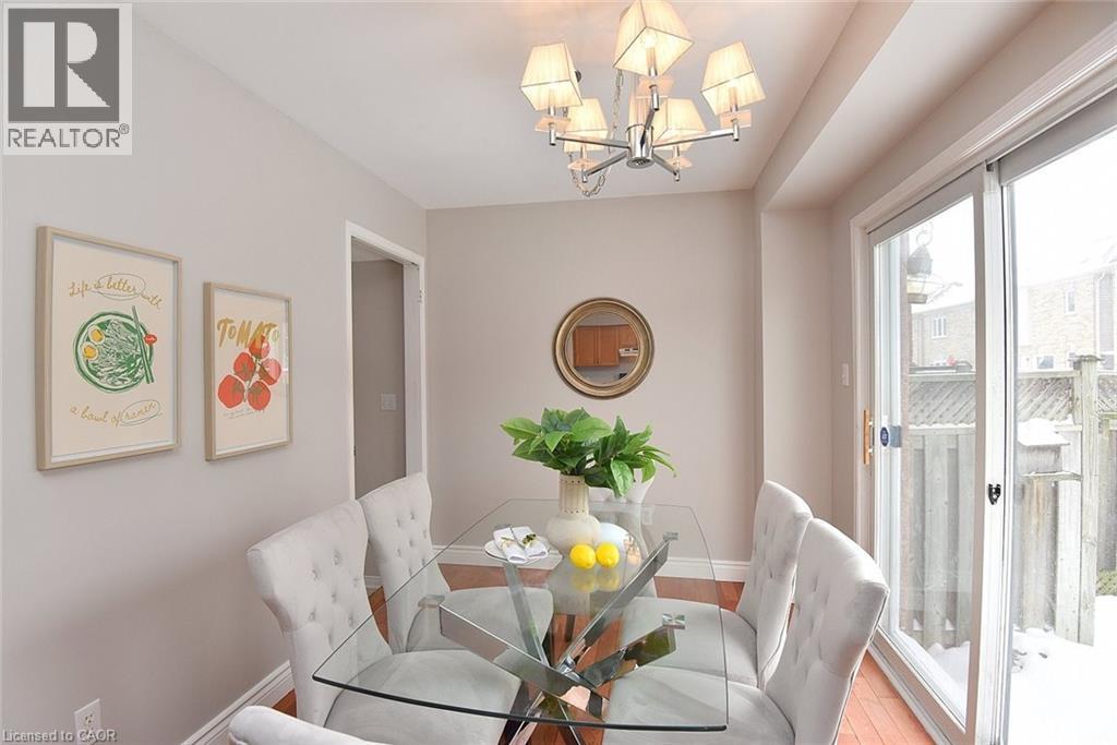 Dining room featuring a chandelier and wood finished floors - 2258 Empire Crescent, Burlington, ON - Indoor Photo Showing Dining Room