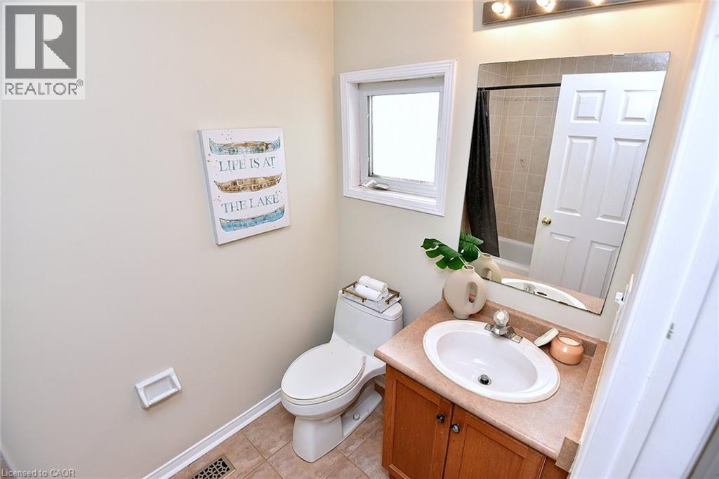Full bath with vanity, shower / bath combo with shower curtain, and light tile patterned floors - 2258 Empire Crescent, Burlington, ON - Indoor Photo Showing Bathroom