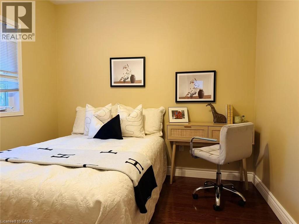 Bedroom with dark wood-style floors and baseboards - 2258 Empire Crescent, Burlington, ON - Indoor Photo Showing Bedroom