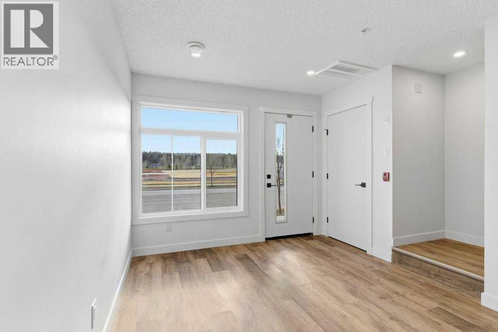 102, 156 Park Street, Cochrane, AB - Indoor Photo Showing Other Room