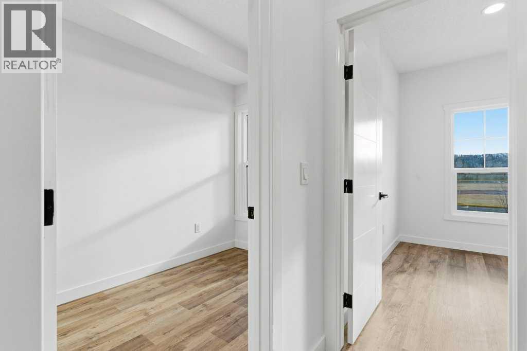 102, 156 Park Street, Cochrane, AB - Indoor Photo Showing Other Room