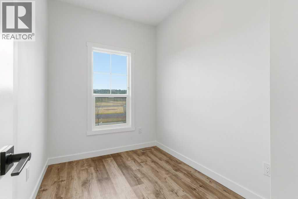 102, 156 Park Street, Cochrane, AB - Indoor Photo Showing Other Room