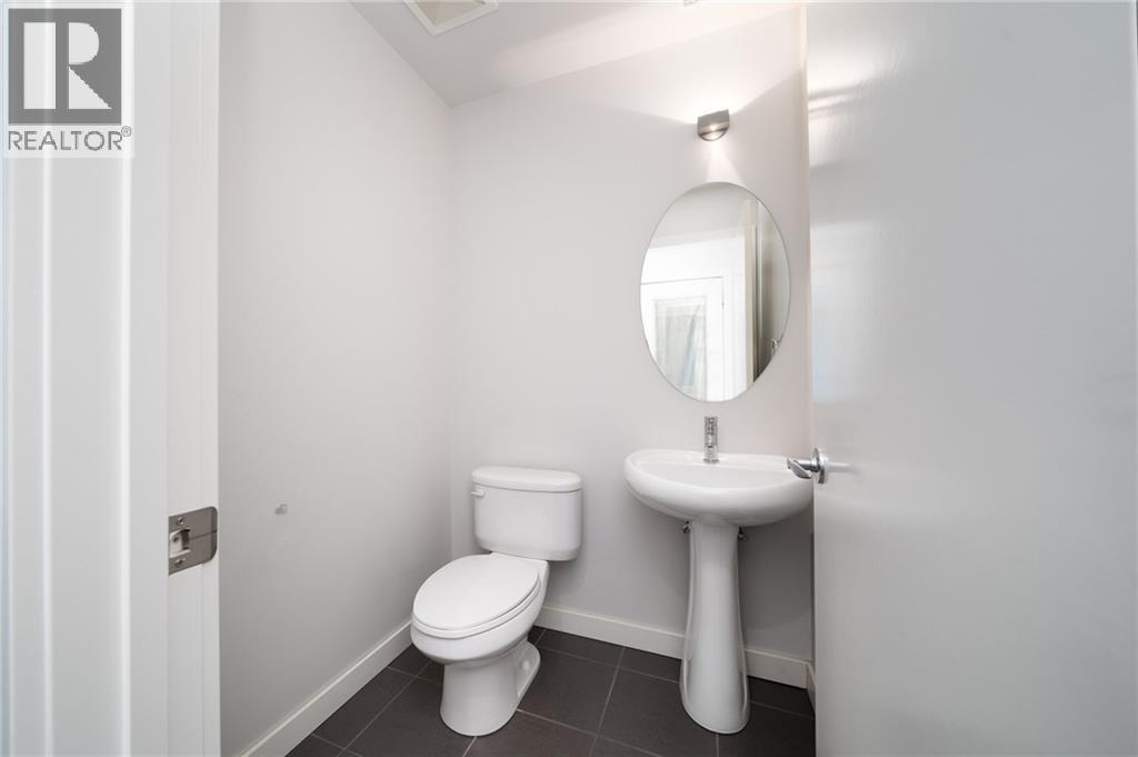 main floor powder room - 1029 1 Avenue Ne, Calgary, AB - Indoor Photo Showing Bathroom