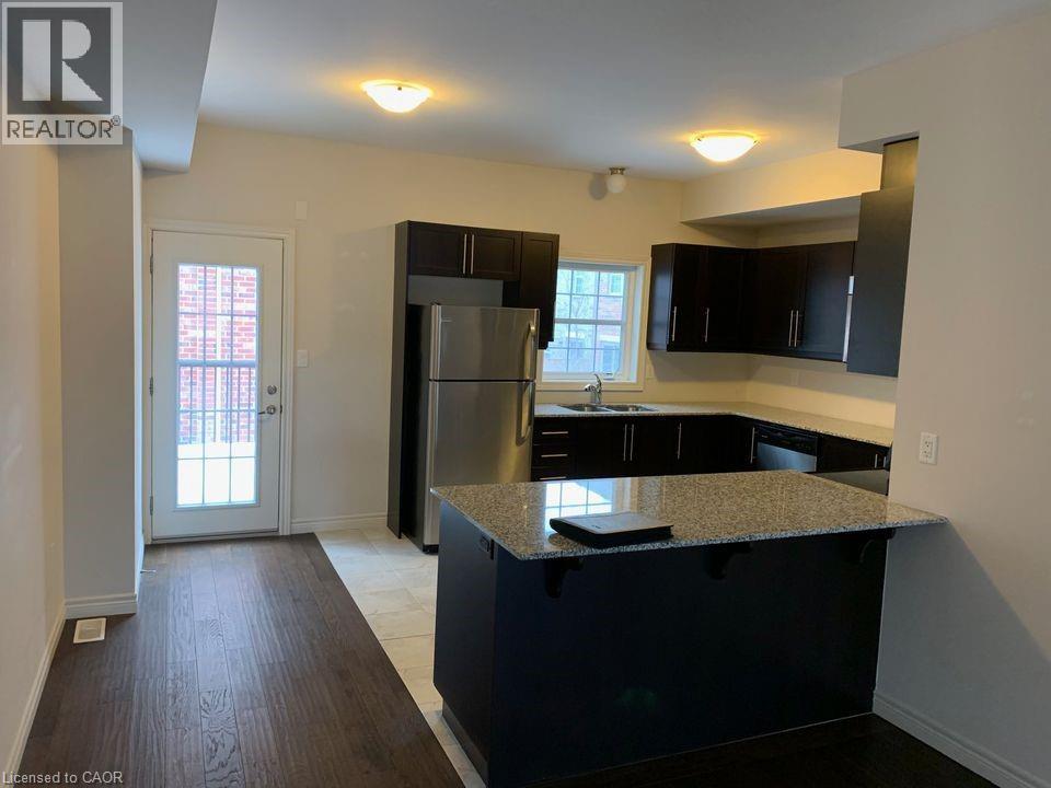 large kitchen with double sink, fridge, stove, microwave range, dishwasher (old photo) - 352 Louisa Street, Kitchener, ON - Indoor Photo Showing Kitchen With Double Sink