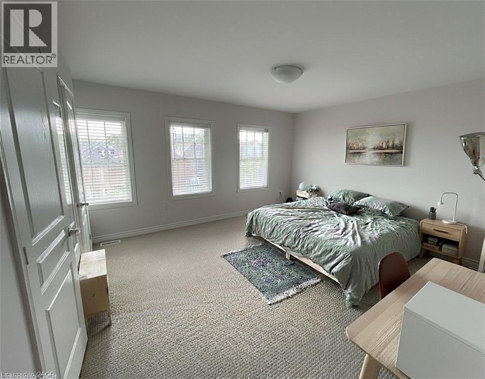 3rd floor primary bedroom with his/her closet, blinds, carpet flooring (old photo) - 352 Louisa Street, Kitchener, ON - Indoor Photo Showing Bedroom