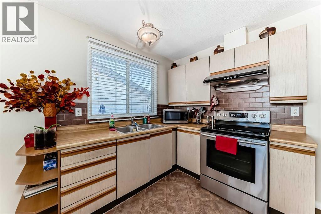 208 Bracewood Road Sw, Calgary, AB - Indoor Photo Showing Kitchen With Double Sink