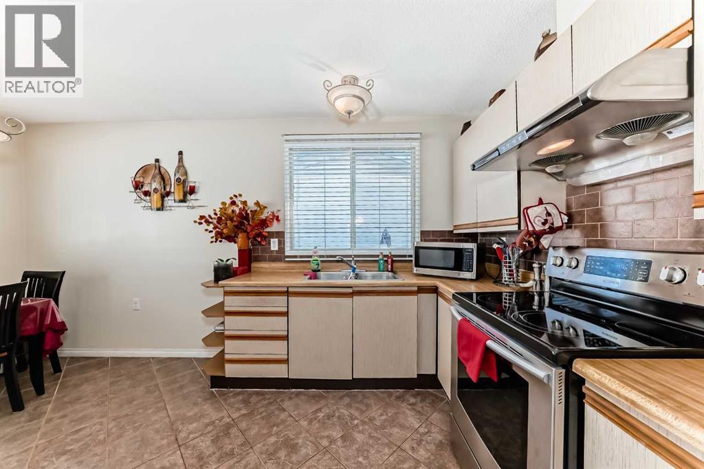 208 Bracewood Road Sw, Calgary, AB - Indoor Photo Showing Kitchen With Double Sink