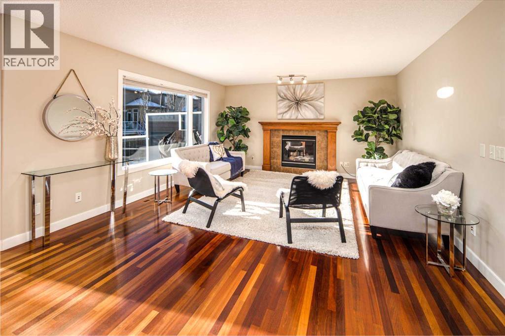 135 Everglade Circle Sw, Calgary, AB - Indoor Photo Showing Living Room With Fireplace