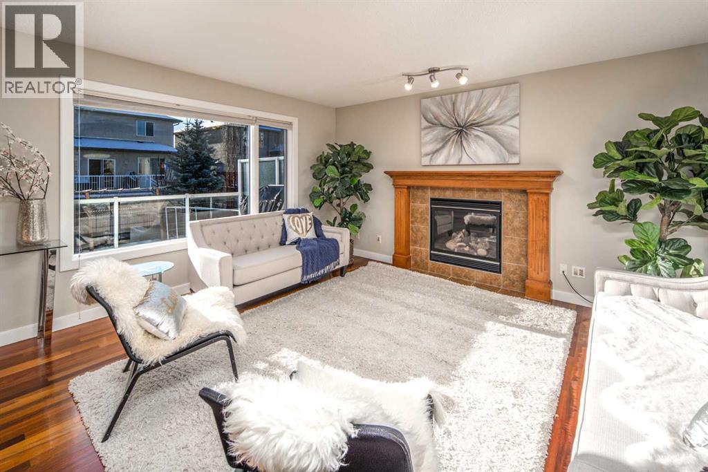 135 Everglade Circle Sw, Calgary, AB - Indoor Photo Showing Living Room With Fireplace