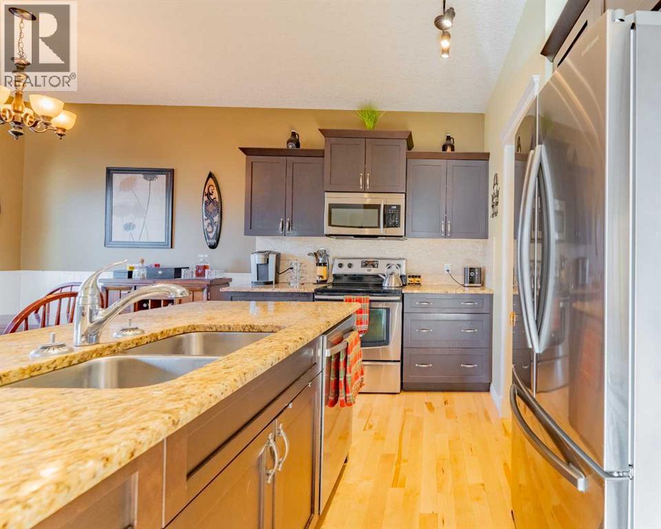 142 West Pointe Circle, Cochrane, AB - Indoor Photo Showing Kitchen With Double Sink