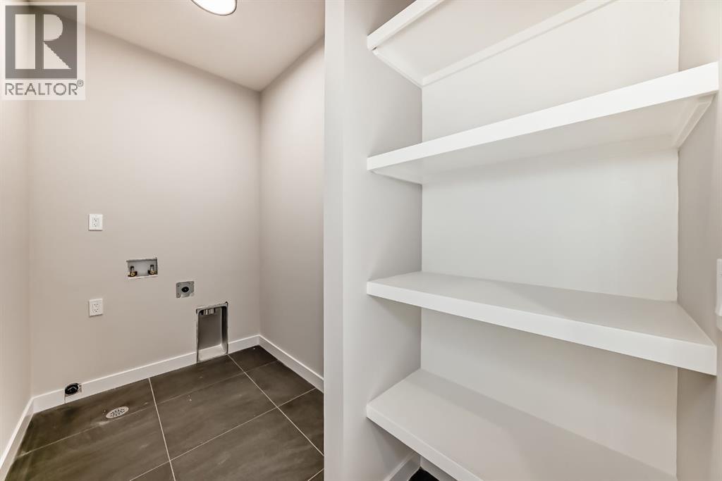 Laundry room with built ins - 504 Heritage Boulevard, Cochrane, AB - Indoor