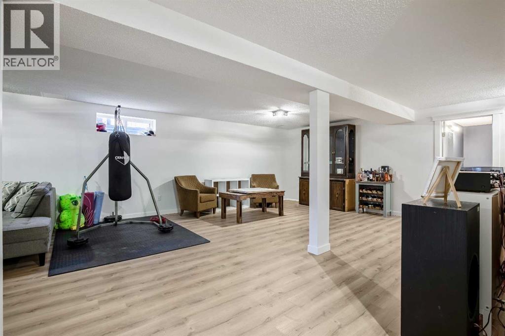 Large Games/Rec Room updated with new laminate flooring and paint 2025 - 830 Westmount Drive, Strathmore, AB - Indoor