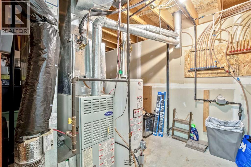 Mechanical room and storage - 830 Westmount Drive, Strathmore, AB - Indoor Photo Showing Basement