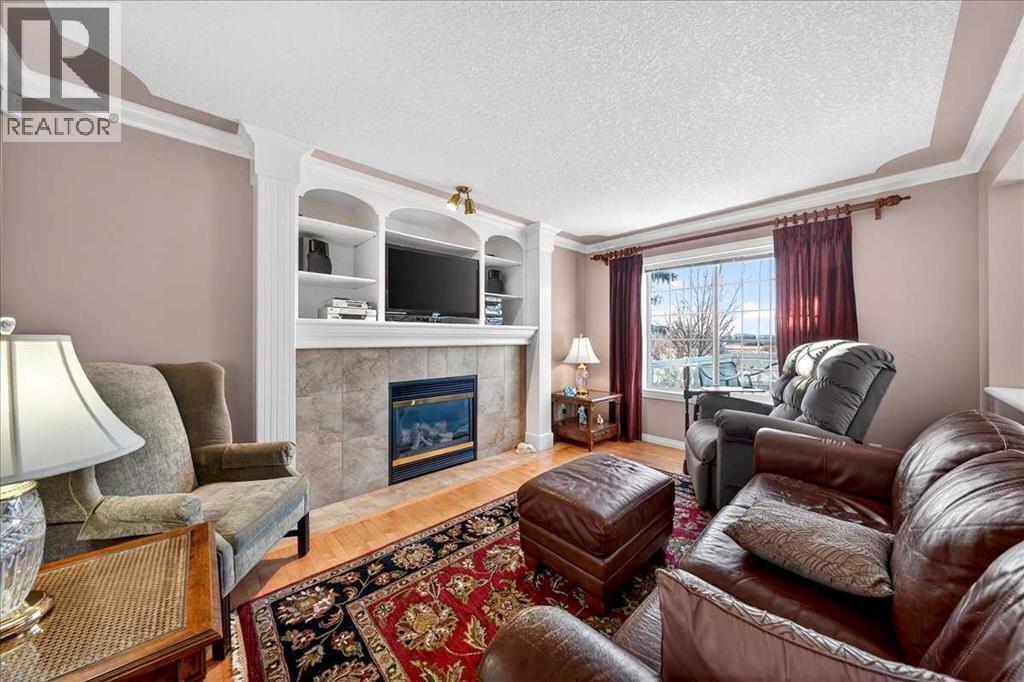 206 Cougarstone Circle Sw, Calgary, AB - Indoor Photo Showing Living Room With Fireplace