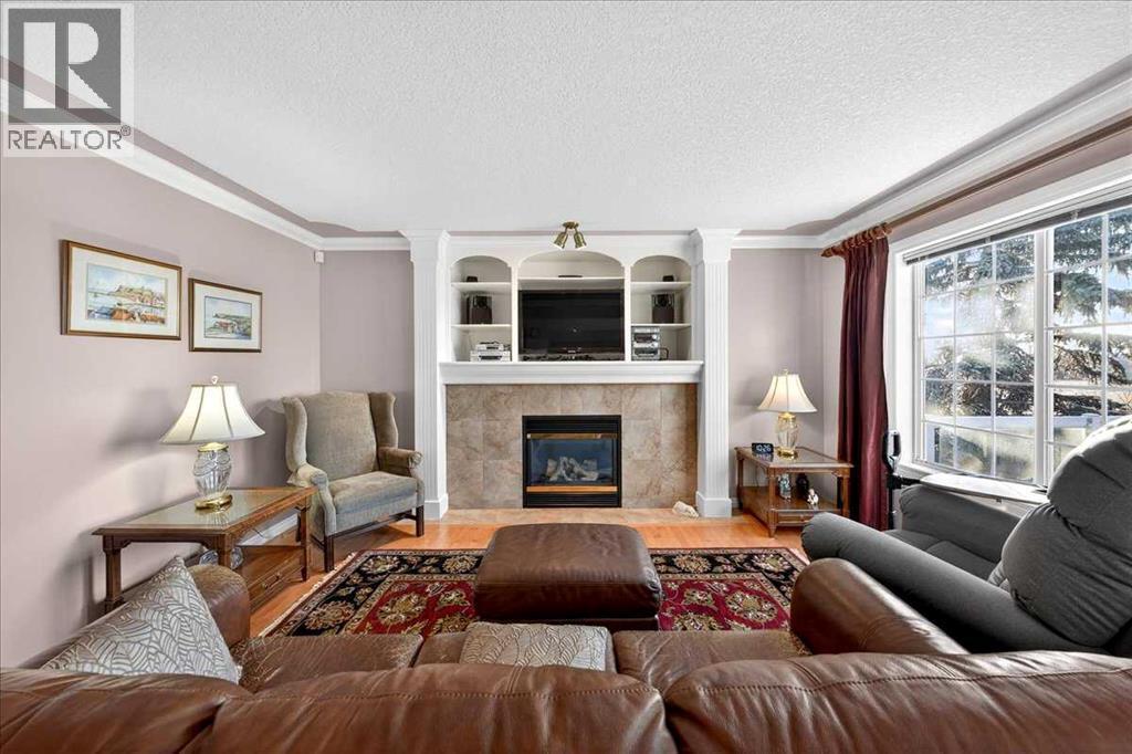 206 Cougarstone Circle Sw, Calgary, AB - Indoor Photo Showing Living Room With Fireplace