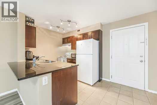 215, 355 Taralake Way Ne, Calgary, AB - Indoor Photo Showing Kitchen With Double Sink