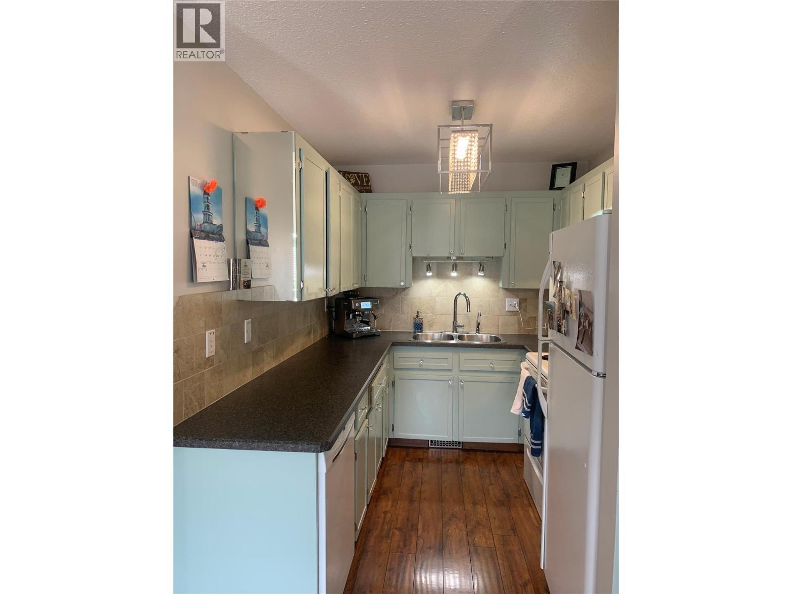 Kitchen when owner was living there - 3155 Gordon Drive Unit# 407, Kelowna, BC - Indoor Photo Showing Kitchen With Double Sink