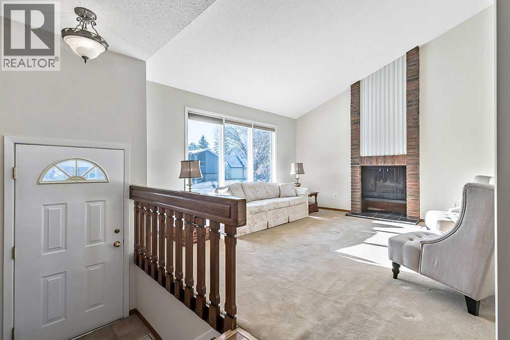 107 Lock Crescent, Okotoks, AB - Indoor With Fireplace