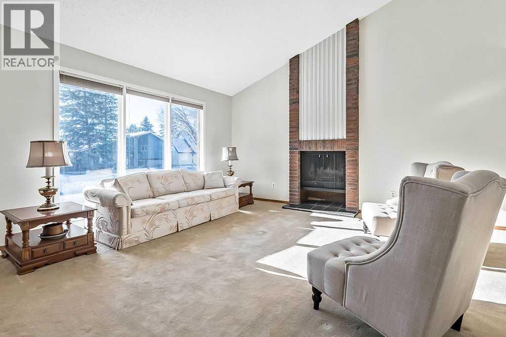 107 Lock Crescent, Okotoks, AB - Indoor Photo Showing Living Room With Fireplace