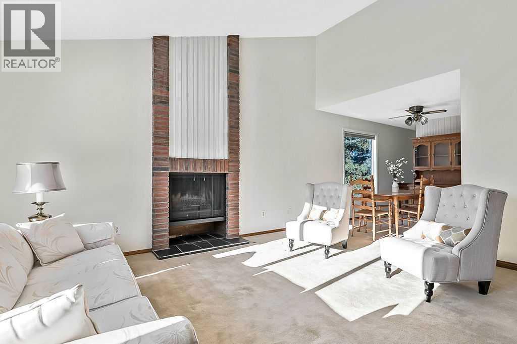 107 Lock Crescent, Okotoks, AB - Indoor Photo Showing Living Room With Fireplace