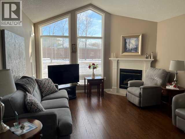 901 Nativity Bay, Rural Rocky View County, AB - Indoor Photo Showing Living Room With Fireplace