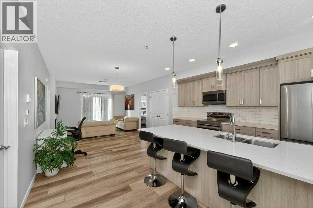 1207, 33 Carringham Gate Nw, Calgary, AB - Indoor Photo Showing Kitchen With Stainless Steel Kitchen With Double Sink With Upgraded Kitchen