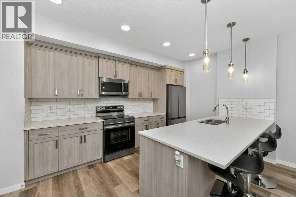 1207, 33 Carringham Gate Nw, Calgary, AB - Indoor Photo Showing Kitchen With Stainless Steel Kitchen With Double Sink With Upgraded Kitchen