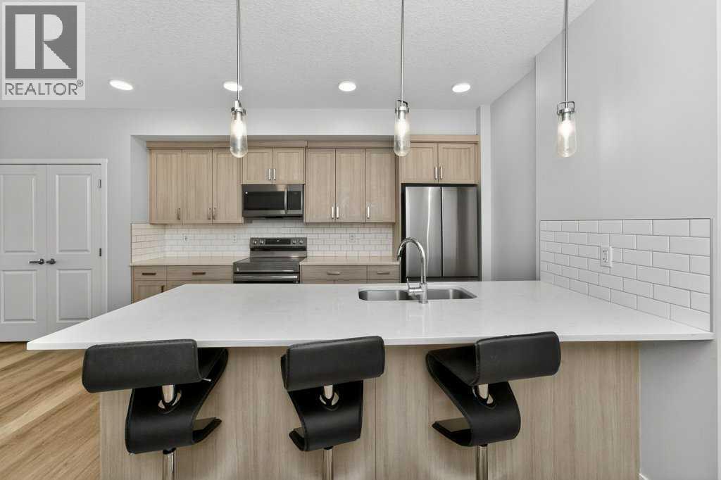 1207, 33 Carringham Gate Nw, Calgary, AB - Indoor Photo Showing Kitchen With Stainless Steel Kitchen With Double Sink With Upgraded Kitchen