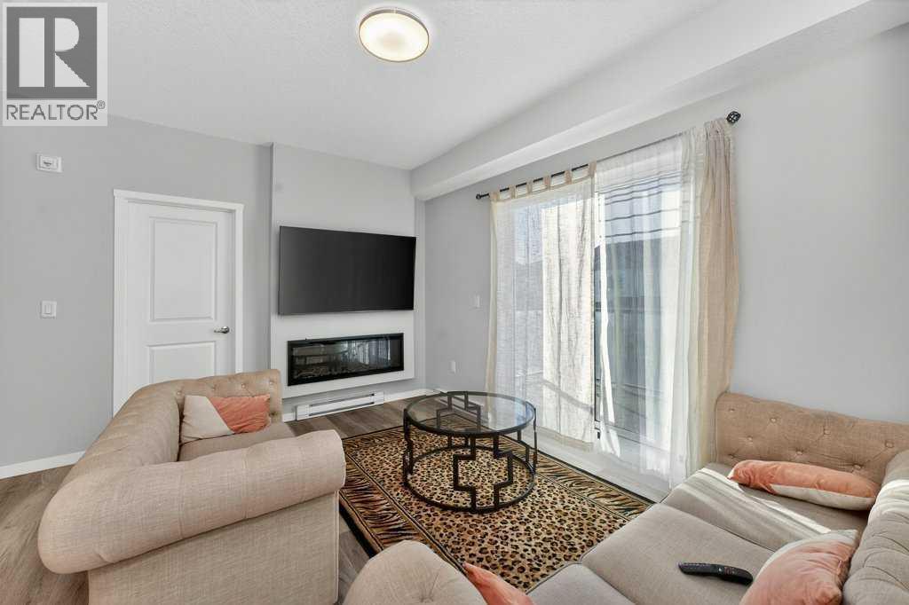 1207, 33 Carringham Gate Nw, Calgary, AB - Indoor Photo Showing Living Room With Fireplace