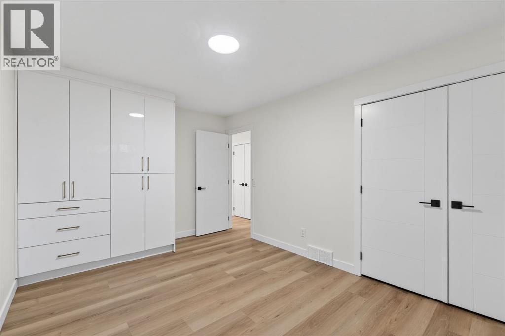 Primary bedroom upstairs with separate custom closet - 420 Pinegreen Close Ne, Calgary, AB - Indoor Photo Showing Other Room