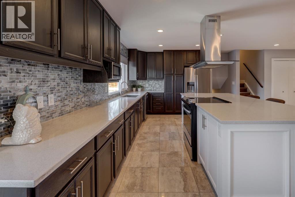 413 Albert Street Se, Airdrie, AB - Indoor Photo Showing Kitchen With Double Sink With Upgraded Kitchen