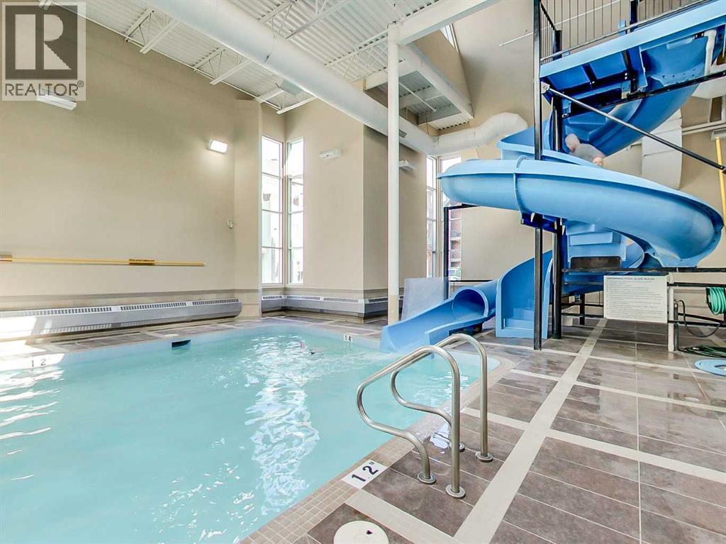 205 Rot. A, 901 Mountain Street, Canmore, AB - Indoor Photo Showing Other Room With In Ground Pool