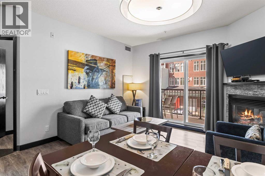 205 Rot. A, 901 Mountain Street, Canmore, AB - Indoor Photo Showing Living Room With Fireplace