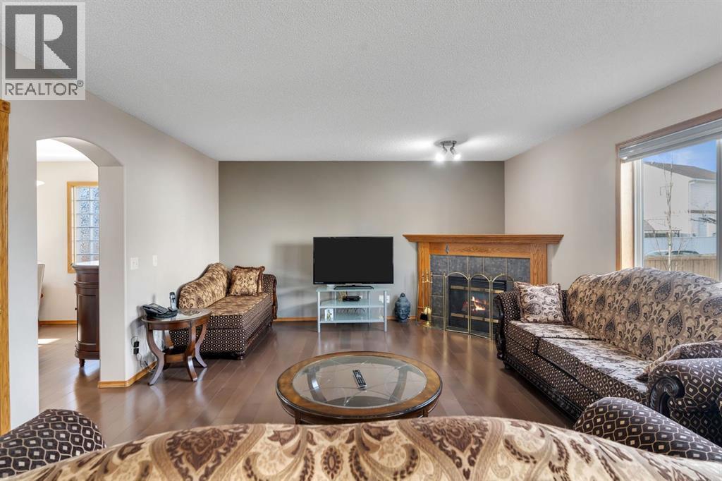 717 Coral Springs Boulevard Ne, Calgary, AB - Indoor Photo Showing Living Room With Fireplace