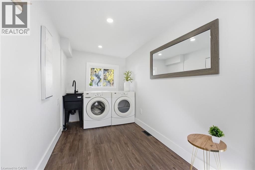 Washroom with dark wood-style flooring, recessed lighting, and independent washer and dryer - 4255 William Street, Beamsville, ON - Indoor Photo Showing Laundry Room