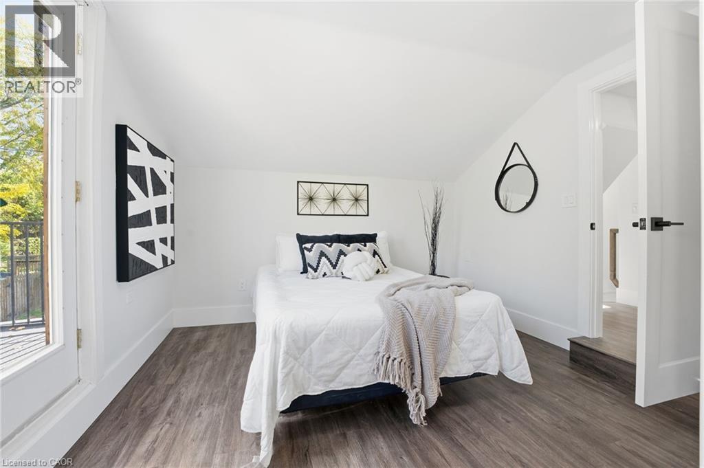 Bedroom with dark wood-type flooring and lofted ceiling - 4255 William Street, Beamsville, ON - Indoor Photo Showing Bedroom
