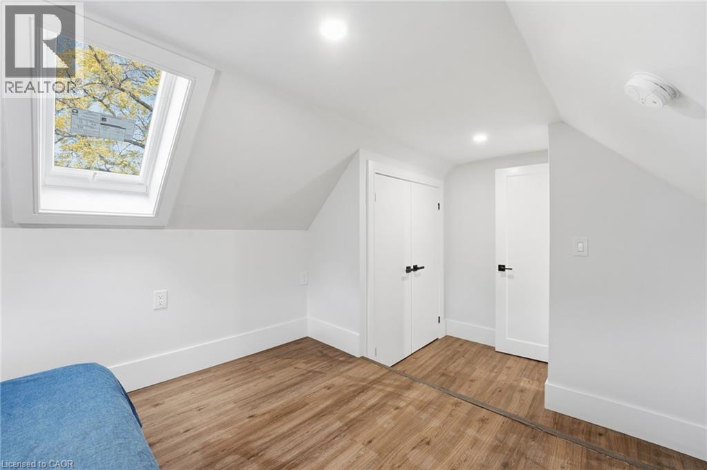 Additional living space featuring lofted ceiling, light wood-type flooring, a skylight, and recessed lighting - 4255 William Street, Beamsville, ON - Indoor Photo Showing Other Room
