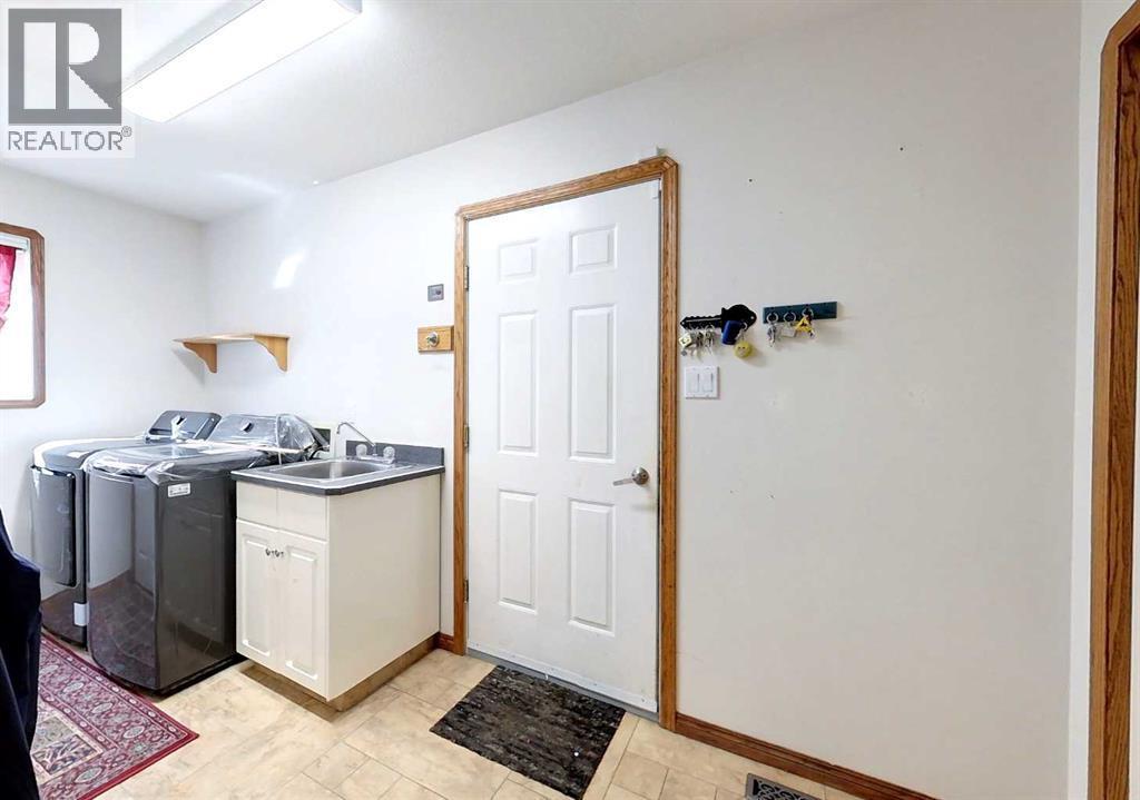23 Springwood Drive Ne, Slave Lake, AB - Indoor Photo Showing Laundry Room