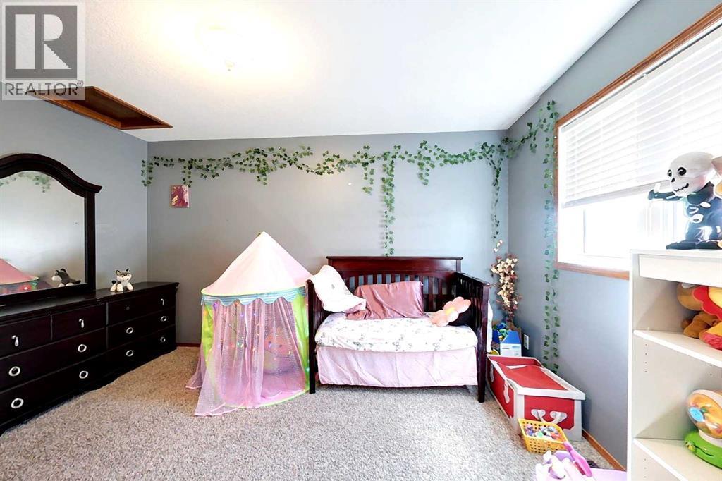 23 Springwood Drive Ne, Slave Lake, AB - Indoor Photo Showing Bedroom
