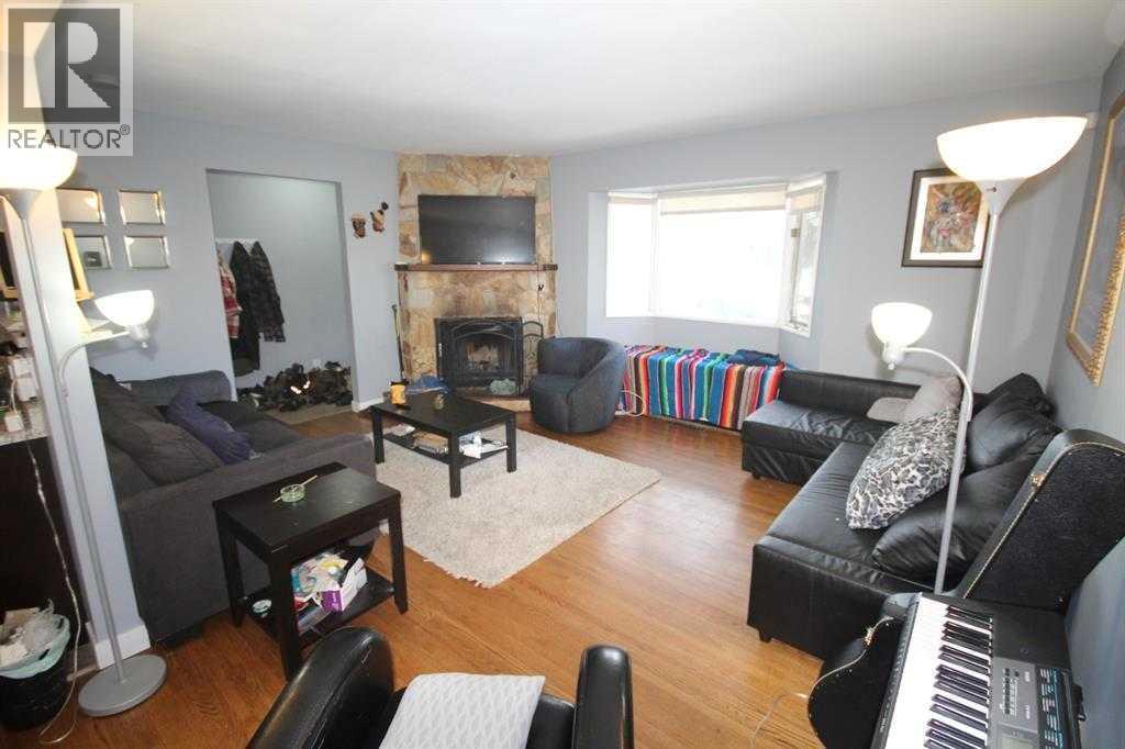 3824 Bantford Drive Nw, Calgary, AB - Indoor Photo Showing Living Room With Fireplace